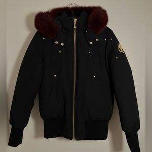 Moose Knuckles 
Black with detachable natural dyed blue fox fur never worn